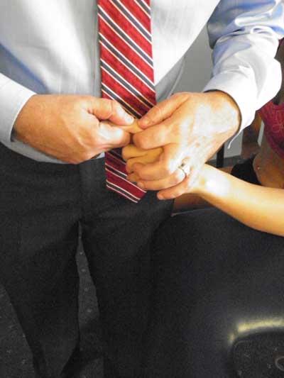 Man and woman holding hands comfortingly.